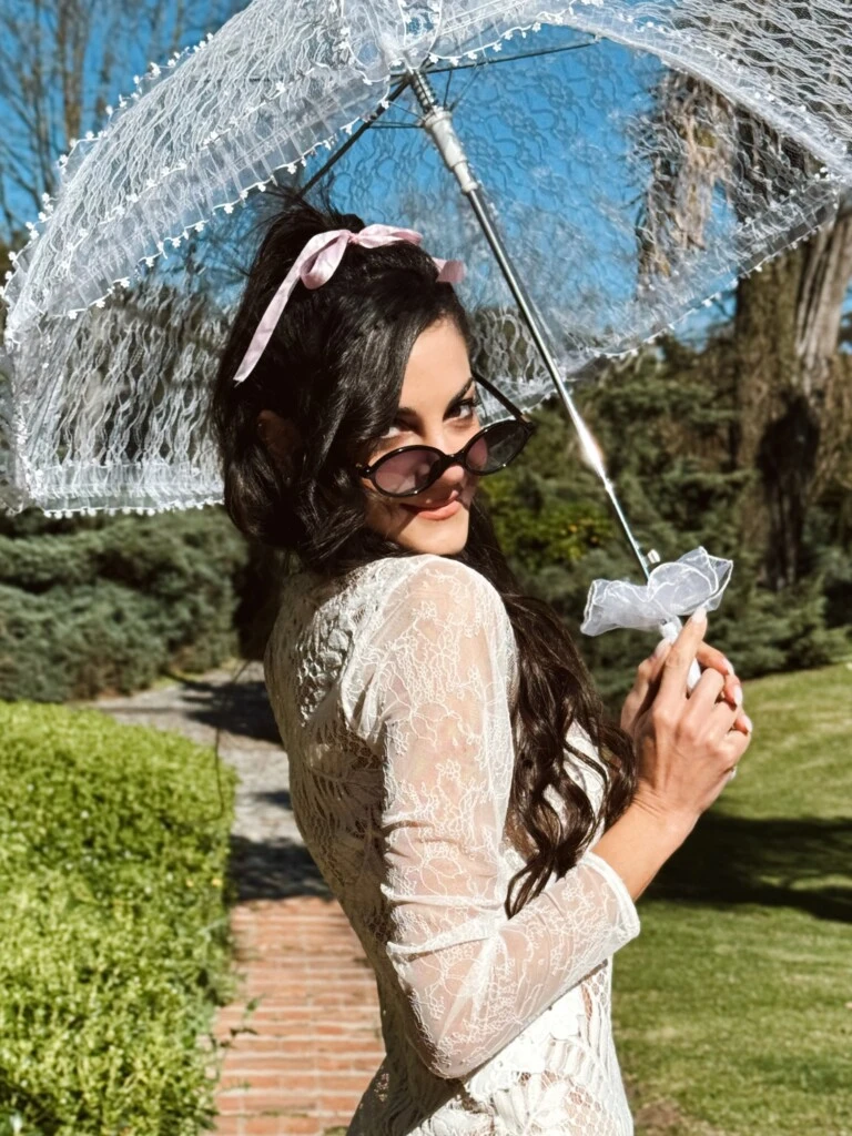 Emily posó en un entorno verde y soleado y sumó un paraguas de encaje blanco, que funcionó como accesorio y al mismo tiempo como una extensión del vestido.